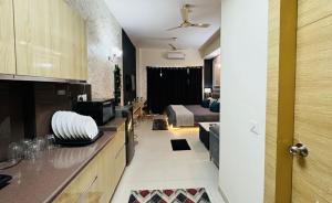 a room with a kitchen and a living room at Mansion Grey Studio in Ghaziabad