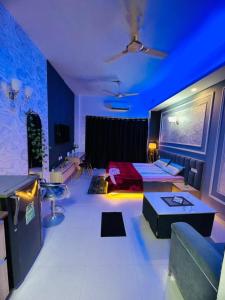 a large room with a bed and a blue ceiling at Mansion Grey Studio in Ghaziabad