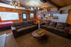 a living room with two couches and a table at Shaver Lake Village Hotel in Shaver Lake