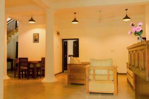 a living room with a table and a dining room at AYUBELLO hostel & suites in Ahungalla +19 photos
