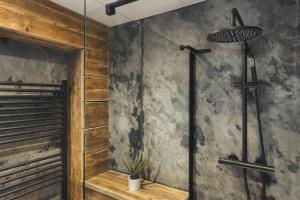 a bathroom with a shower with a glass door at Windermere Central Hotel - Central Lake District Hotel in Windermere - Ridgestone in Windermere