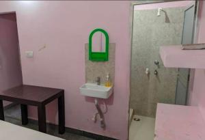 a pink bathroom with a sink and a shower at Sri Hotel Ganga Couple&Family Friendly in Patna