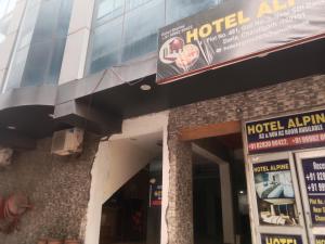 a hotel entrance with a sign on the side of a building at Hotel Alpine in Chandīgarh