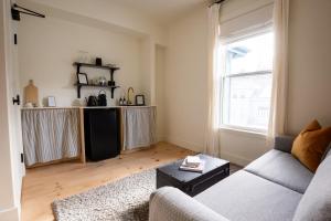 a living room with a couch and a window at The August House in Windsor +40 photos
