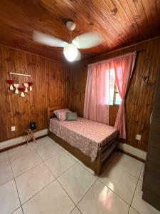 a bedroom with a bed and a ceiling fan at Rincón de Juanita in Rivera +5 photos