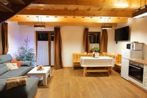 a living room with a couch and a table at Chata Relax 1 in Pribylina