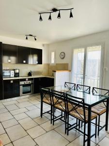 a kitchen with a glass table and chairs in it at "Le Cade" - Résidence Rive Gauche in Les Salles-sur-Verdon