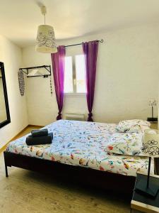 a bedroom with a bed with purple curtains and a window at "Le Cade" - Résidence Rive Gauche in Les Salles-sur-Verdon