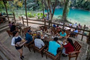 a group of people sitting at a table eating food at Casa Lorette in Martínez