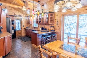 a large kitchen with wooden cabinets and a table at Northern Acres in Lake George