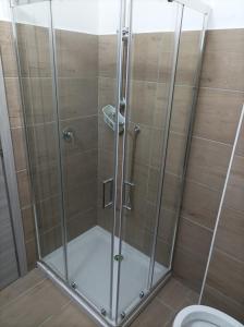 a shower stall in a bathroom with a toilet at Brezza Marina in Cirella +24 photos