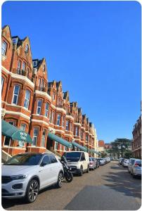 a row of cars parked in front of buildings at West Cliff Studio - Private Garden mins from Beach in Bournemouth