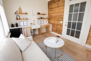 a living room with a white couch and a table at The August House in Windsor