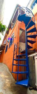 a blue staircase leading up to a house at Pinheiros Hostel & Food in São Paulo