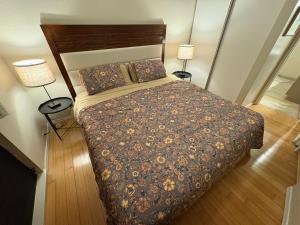 a bedroom with a large bed with two lamps at Beachfront 1 Bedroom Condo with Private Beach, Pool, Hot Tub in Pahala +22 photos