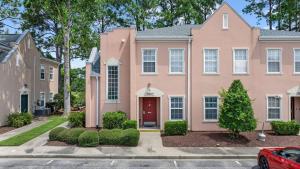 a pink house with a red door at Myrtle Golf Escape At Legends-Pool-Pet Friendly in Myrtle Beach