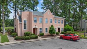 a red car parked in front of a pink house at Myrtle Golf Escape At Legends-Pool-Pet Friendly in Myrtle Beach