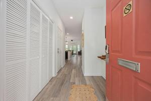 a hallway with a red door and a rug at Myrtle Golf Escape At Legends-Pool-Pet Friendly in Myrtle Beach