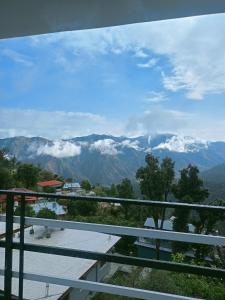 a view of the mountains from the balcony of a house at Chill with pahadi in Lansdowne