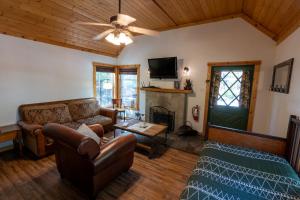 a living room with a couch and a fireplace at Shaver Lake Village Hotel in Shaver Lake