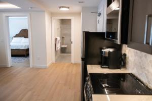 a kitchen with a refrigerator and a room with a bed at Treadwell Mansion in Portsmouth +36 photos