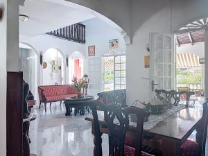 a living room with a table and chairs at Villa Soleïa in Gourbeyre