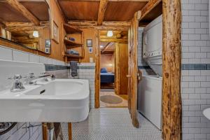 a bathroom with a sink and a washing machine at Mountain Air Cabin in Welches +47 photos