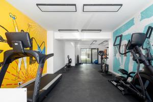 a gym with treadmills and bikes in a room at Silarent Niechorze Parkowa 3 in Niechorze