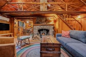 a living room with a couch and a fireplace at Mountain Air Cabin in Welches