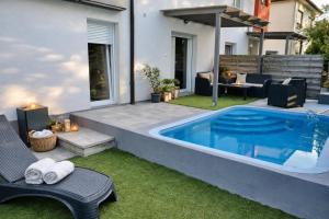 a swimming pool in the backyard of a house at Happy Home Apartman in Siófok
