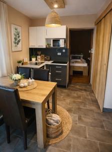 a kitchen with a table and a dining room at Happy Home Apartman in Siófok
