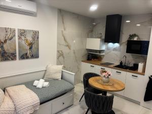 a small room with a table and a kitchen at Little Home in Piešťany +22 photos