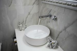 a bathroom with a sink and an elephant toy on a counter at Enalios House in Vourvoúlos +26 photos