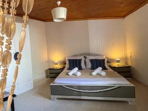 a bedroom with a large bed with two pillows at Kritamos Beach House - Near the Beach with Easy Parking in Matala