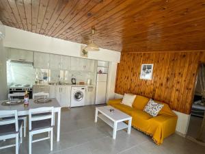 a living room with a couch and a table at Kritamos Beach House - Near the Beach with Easy Parking in Matala +13 photos