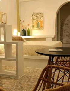 a bedroom with a bed with a table in front of it at Overhill Apartments Adamas in Adamantas