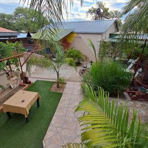 a garden with a table and a bench on grass at Okahandja Guesthouse in Okahandja