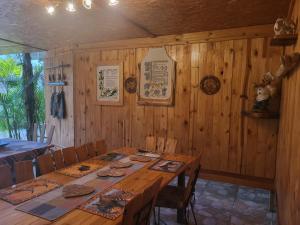 a wooden dining room with a table and chairs at Okahandja Guesthouse in Okahandja