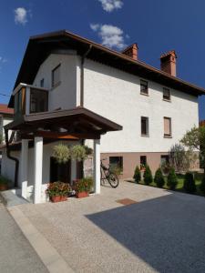 a white house with a bike parked in front of it at Apartma Rutar in Tolmin