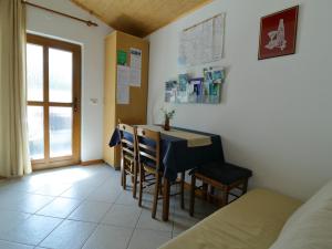 a room with a table and chairs and a bed at Apartma Rutar in Tolmin