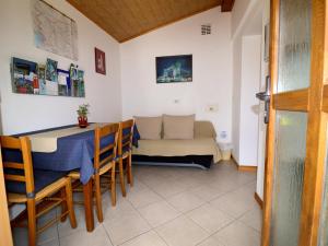 a dining room with a table and a couch at Apartma Rutar in Tolmin