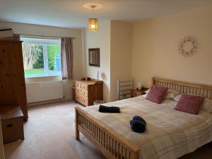 a bedroom with a large bed and a window at Jacuma in Rhosneigr