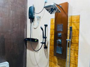 a shower stall with a phone on the wall at Chanco Beach Hotel and Coworking - Negombo in Negombo +63 photos