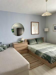 a bedroom with two beds and a mirror at Vila 'Anna' in Krapets