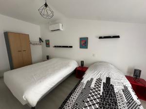 a bedroom with two beds in a room at Appartement terrasse en ville in Blois