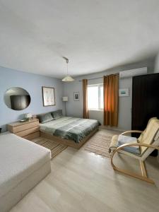 a bedroom with a bed and a chair in it at Vila 'Anna' in Krapets