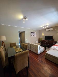 a living room with a bed a couch and a table at Departamento Casco Historico in La Porteña +96 photos