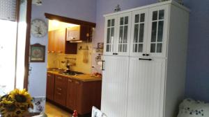 a kitchen with a large white cabinet in a room at a sunny place in Silvi Marina