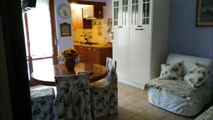 a living room with a table and a chair and a kitchen at a sunny place in Silvi Marina