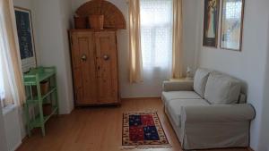 a living room with a couch and a cabinet at Vila Jitka in České Budějovice